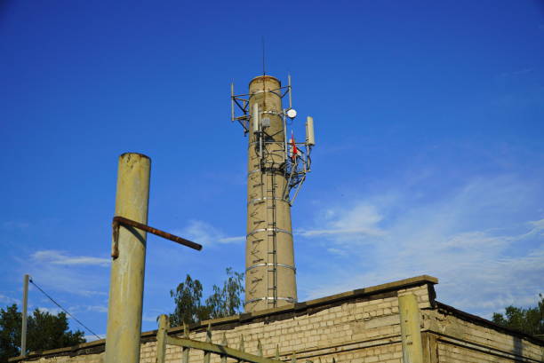 istock Old red brick tower against the clear blue sky background. Belfry for telecommunications. High pipe boiler house. 1410027434