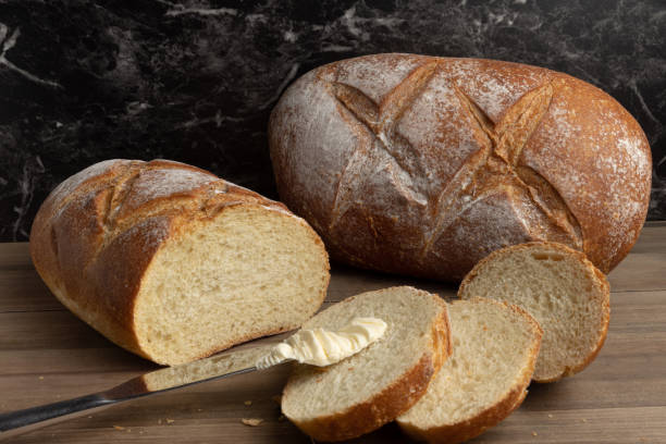 istock Loaf of fresh baked bread on table 1410030914