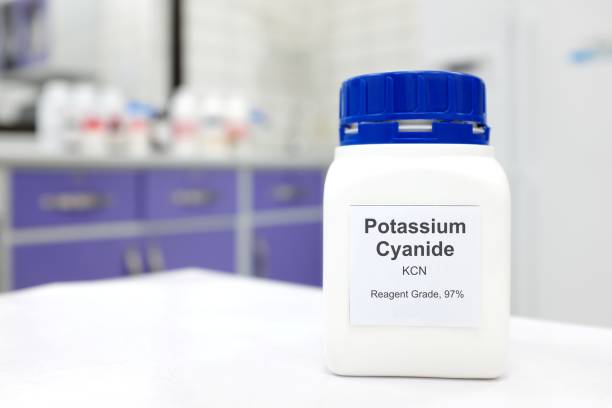 istock Selective focus of a bottle of Potassium Cyanide pure chemical compound. White laboratory background. 1410032550