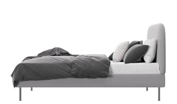 istock Double bed isolated on white background. Side view. Modern furniture. Grey and white bedding. Beautiful bed, contemporary style. 3D rendering. 1410033017
