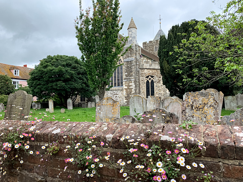 The churchyard and tombstones at the church of St. Mary the Virgin in the historic Cinque Port town of Rye, East Sussex, UK