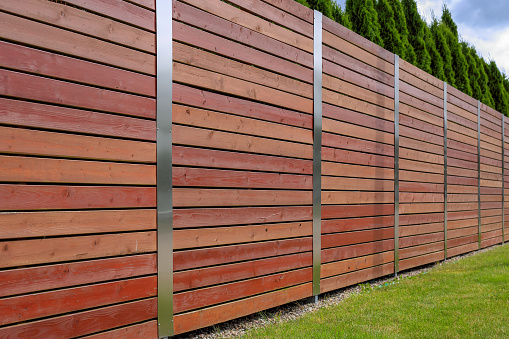Wooden fence with metal elements in Poland