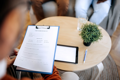 Therapist on a meeting with a couple, holding a report in hands