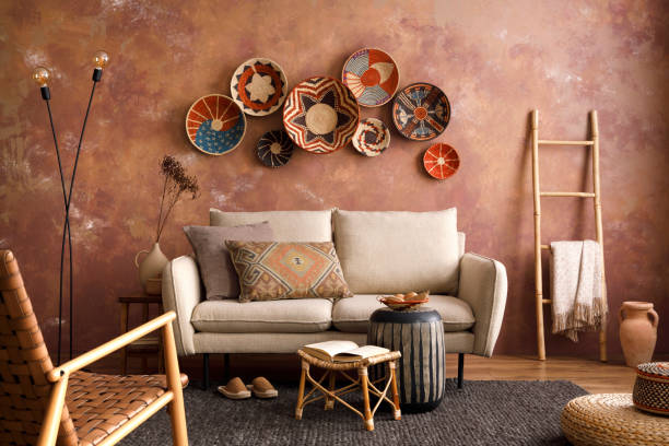 istock The stylish boho compostion at living room interior with design beige sofa, coffee table, wicker baskets and elegant personal accessories. Brown and white pillows and plaid. Cozy apartment. Home decor 1410040635