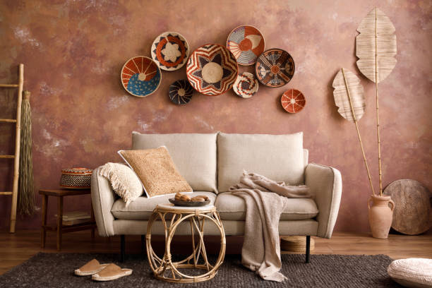 istock The stylish boho compostion at living room interior with design beige sofa, coffee table, wicker baskets and elegant personal accessories. Brown and white pillows and plaid. Cozy apartment. Home decor. 1410041207