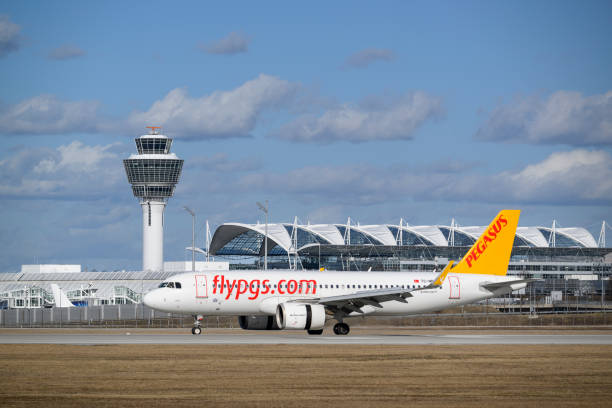 Pegasus Airbus A320-251NEO with the aircraft registration TC-NBE is landing on the southern runway 26L of the Munich Airport MUC EDDM Munich, Germany - February 19. 2022 : Pegasus Airbus A320-251NEO with the aircraft registration TC-NBE is landing on the southern runway 26L of the Munich Airport MUC EDDM munich airport stock pictures, royalty-free photos & images