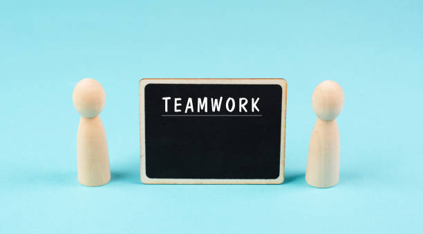 istock The word teamwork is standing on a chalkboard, working together, corporate in team, communication and support concept 1410041933