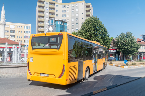 Pristina, Kosovo - June 5, 2022: Yellow city bus in Pristina city.