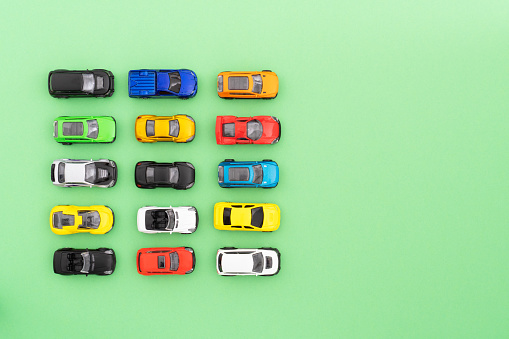Set of colorful toy cars on green background.