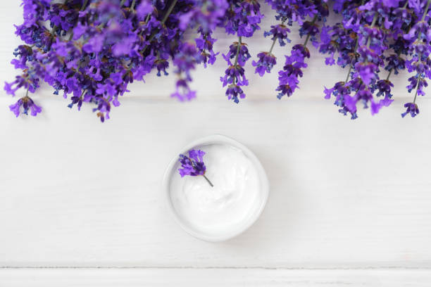 istock Cosmetic cream with lavender flowers top view 1410043527