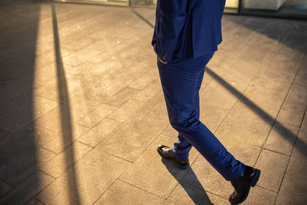 Man in dress shoes with concrete floor and copy space