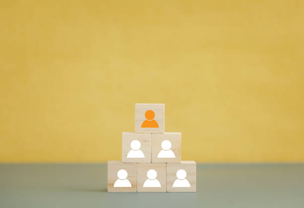 istock wood cube blocks with man icon arranged on yellow background topped with different color icon 1410046484