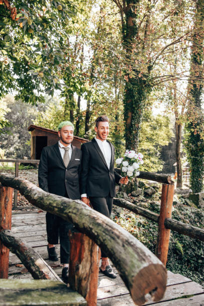 istock gay couple walking together after the bride 1410050687