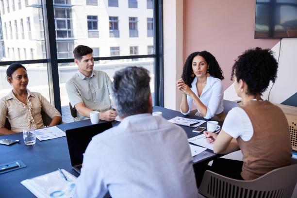 istock Manager talking with her team during a meeting in an office boardroom 1410050877