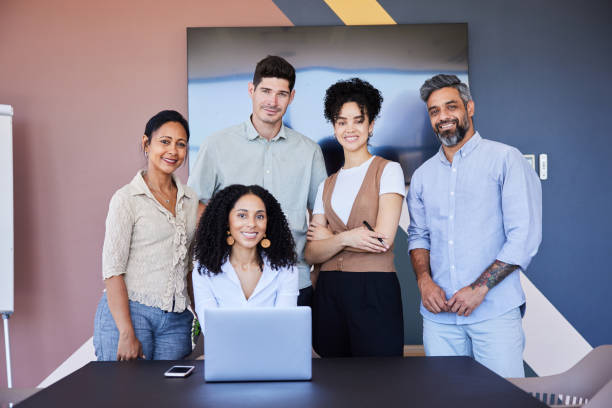 istock Smiling businesspeople working on a laptop during a boardroom meeting 1410051005