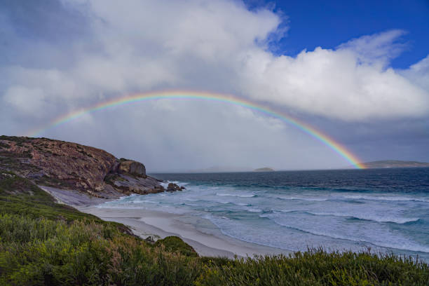istock A rainbow over the beach and rocks 1410052889
