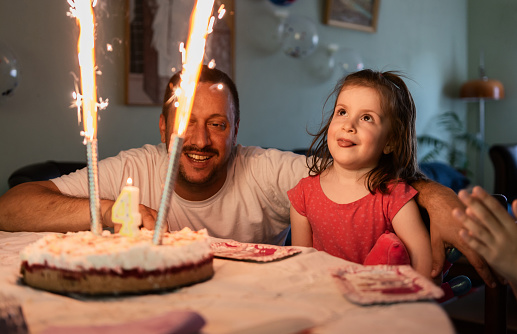 Little girl celebrating birthday whit her family at home