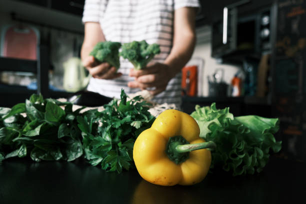 Woman is unpacking fresh vegetables she just bought