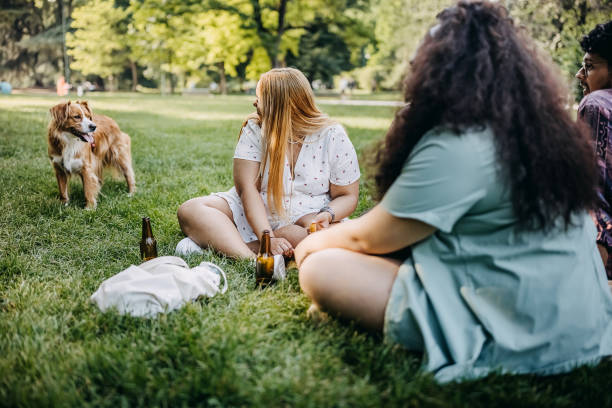 Friends enjoying picnic with a dog