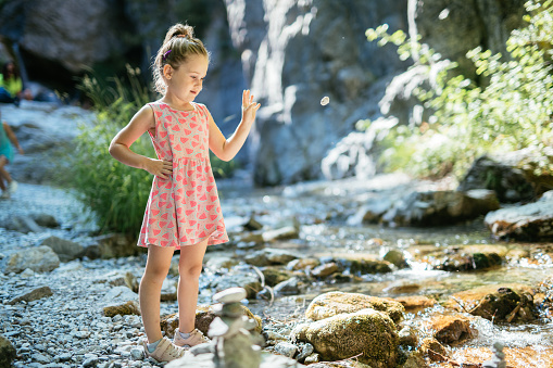 Five year old Caucasian girl enjoying time in nature during summer holiday