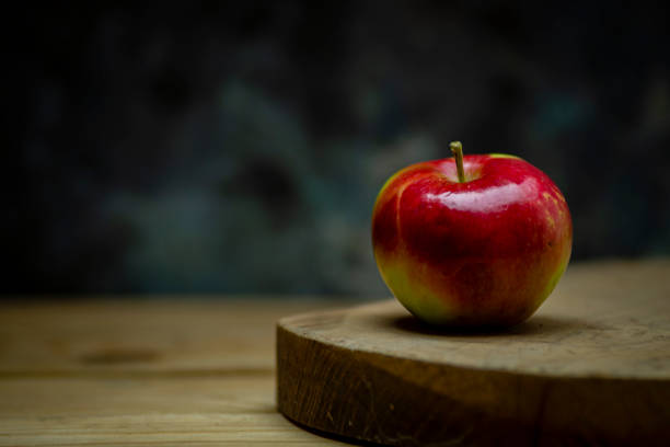 istock red delicious apple on wooden table Black Background space for text SUMMER 1410056683