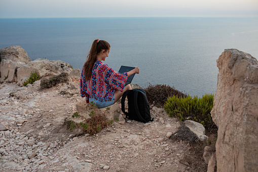 Young woman enjoying beautiful view while working remotely