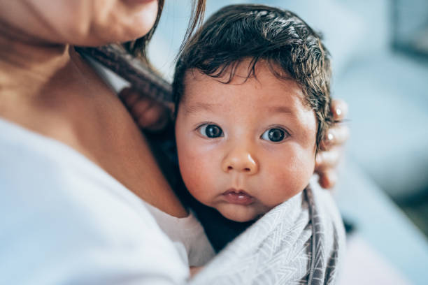 istock Unrecognizable young mother with her son in sling. 1410057029