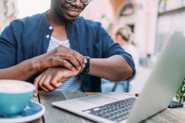 istock Young man sitting in coffee shop and using laptop. 1410057043