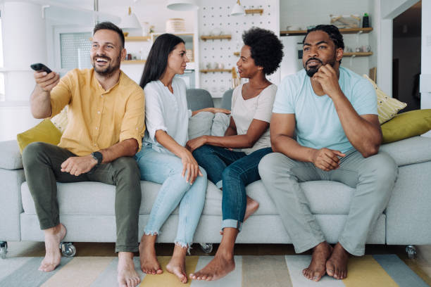 istock Cheerful friends watching TV at home. 1410057069