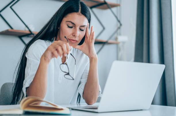 istock Stressed woman using laptop at home. 1410057114