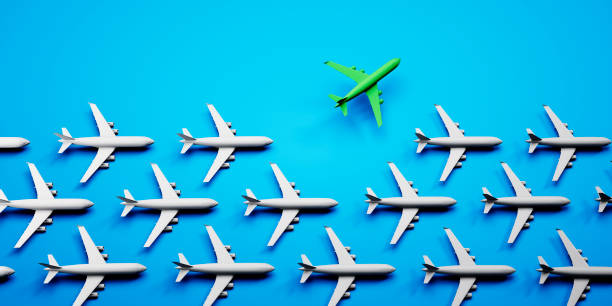 istock Group of white airplanes with green leader 1410057822