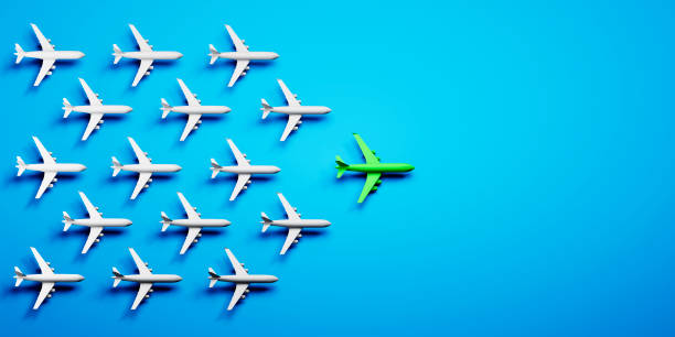 istock Group of white airplanes with green leader 1410057823