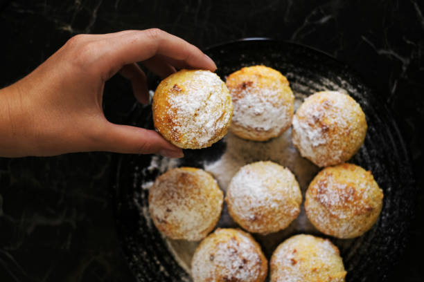 istock female hand holding a muffin top view close-up 1410058114