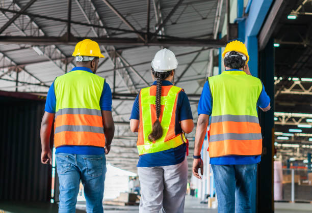 istock Manager and supervisor taking inventory in warehouse, Foreperson making plans with warehousemen, Workers team working in warehouse 1410060925