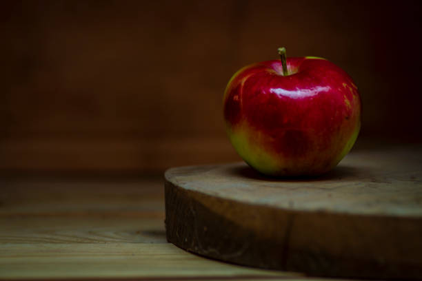 istock red delicious apple on wooden table Black Background space for text SUMMER 1410061618