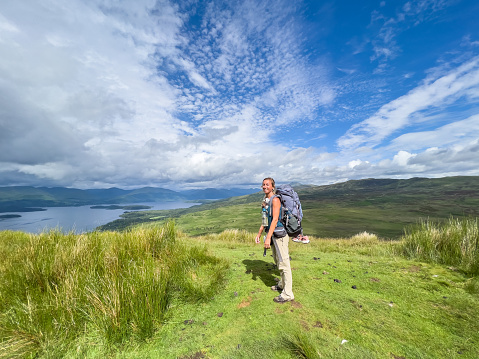 Young woman backpacking on the West Highland way in Scotland.