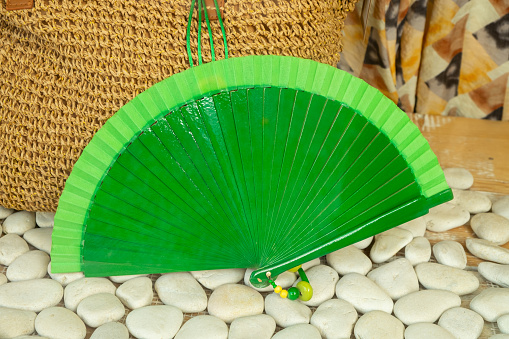 A fan in a store with a bag background of natural ropes and white stones