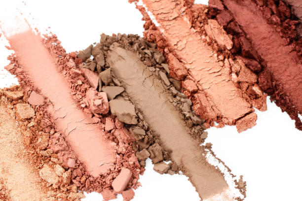 istock Broken and smashed make-up eyeshadow pallete, lay of brush strokes, on white background, top view. Sample cosmetics concept 1410064171