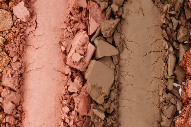 istock Broken and smashed make-up eyeshadow pallete, lay of brush strokes, close-up for background, top view 1410064360