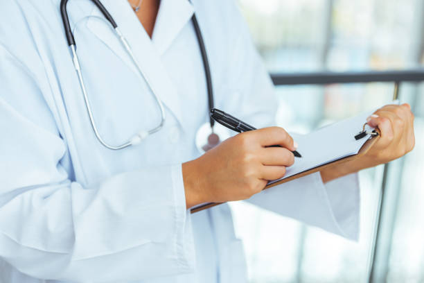 istock Doctor writing notes in a clipboard in a modern hospital 1410064362