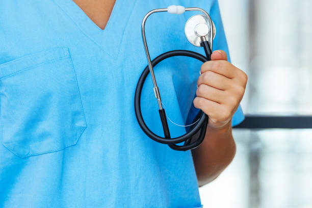 istock Close up view of professional nurse with stethoscope standing 1410064489