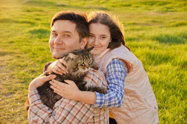 istock Smiling little girl hugging her father outside 1410065189