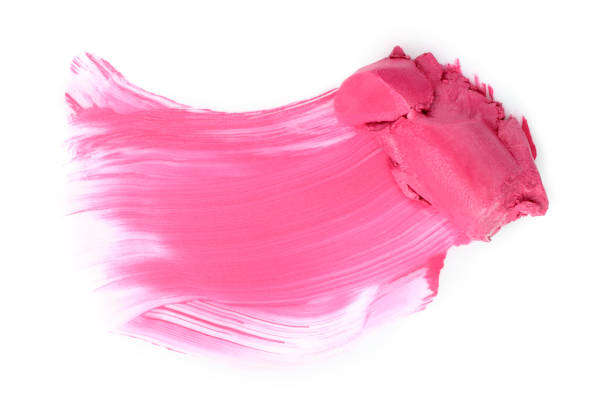 Pink lipstick smear smudge on white background close-up