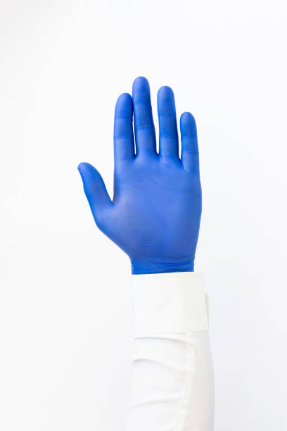 istock Hand in blue latex Glove. Stop sign. White background. Copy space 1410065667