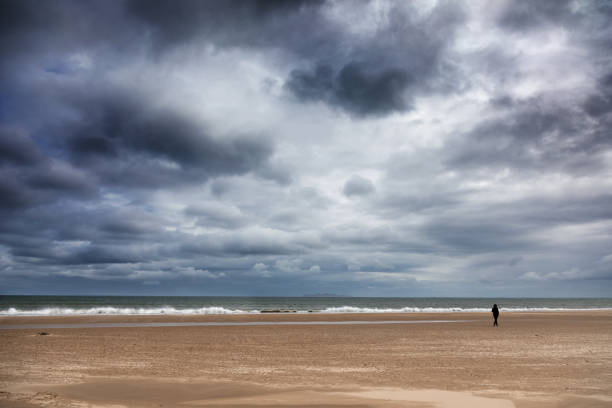 istock Solitary figure at Harve Aubert beach 1410065736