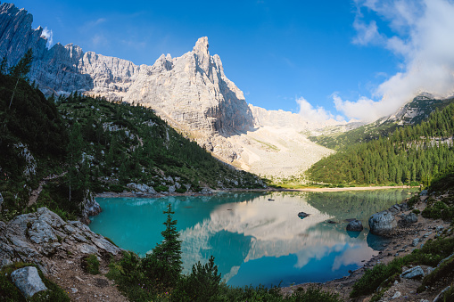 Stunning view of Lake Sorapis with its turquoise waters and surrounded by beautiful rocky mountains.  Lake Sorapis is one of the most beautiful excursions in the Dolomites, Italy.