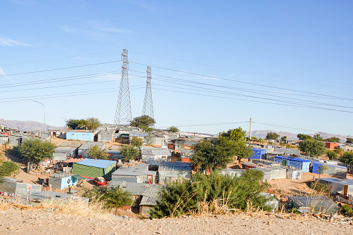 Electricity Pylon at Katutura Township near Windhoek in Khomas Region, Namibia, with people and commercial signs visible.