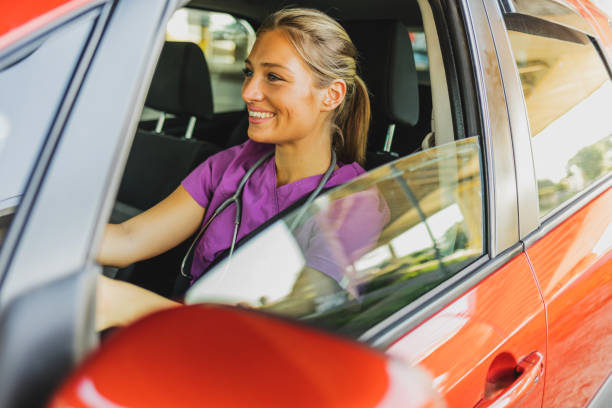 istock Cheerful nurse drives to work. 1410067163