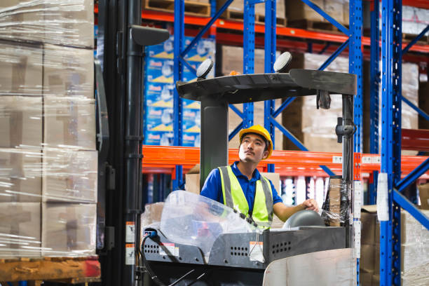 istock Worker on forklift, Manual workers working in warehouse, Worker driver at warehouse forklift loader works 1410067194