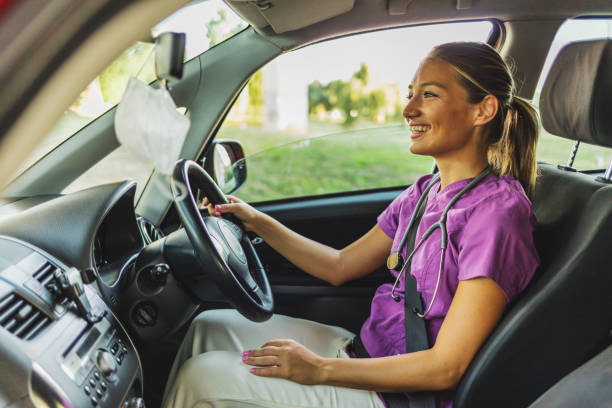 istock Nurse drives to work wearing her scrubs uniform. 1410067491